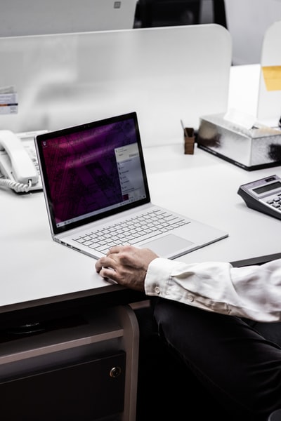 People use the macbook pro in the black coat
